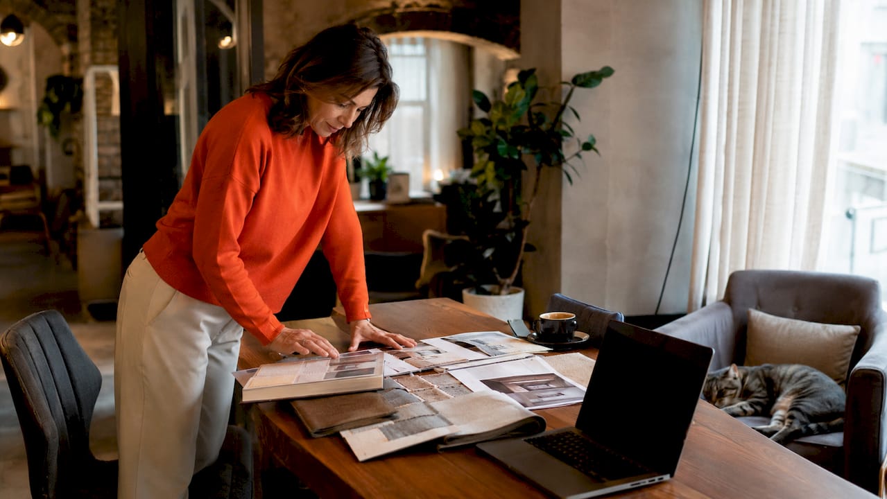 Woman reviewing luxury furniture samples at home