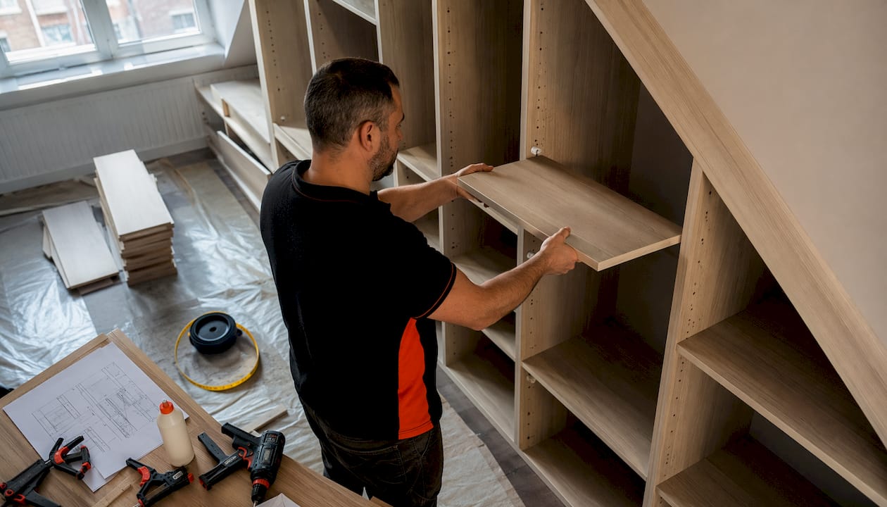 -installation hands fitting loft wardrobe shelf