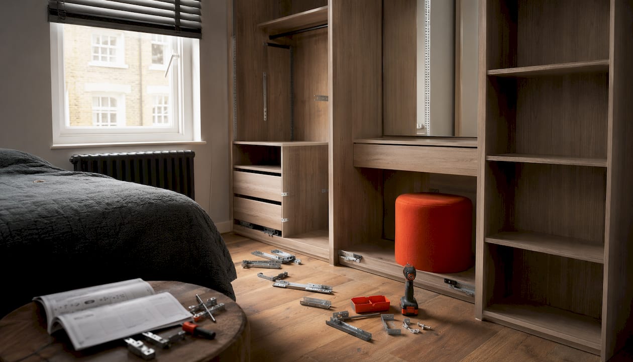 Small bedroom fitted wardrobe installation scene