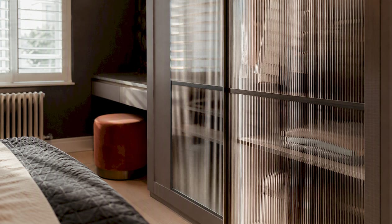 Reeded glass wardrobe door with textured vertical ridges