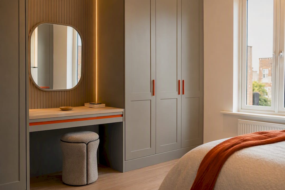 Ergonomic stool and tilted mirror at dressing table