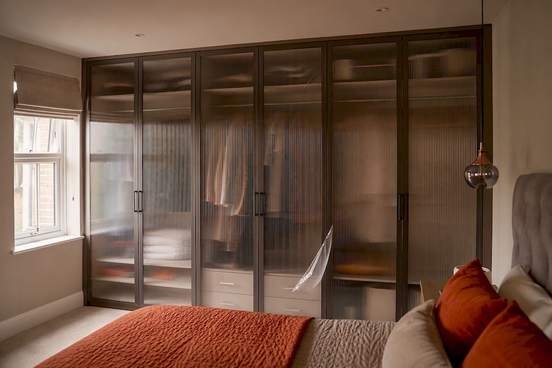 Bespoke reeded glass wardrobe doors in bedroom