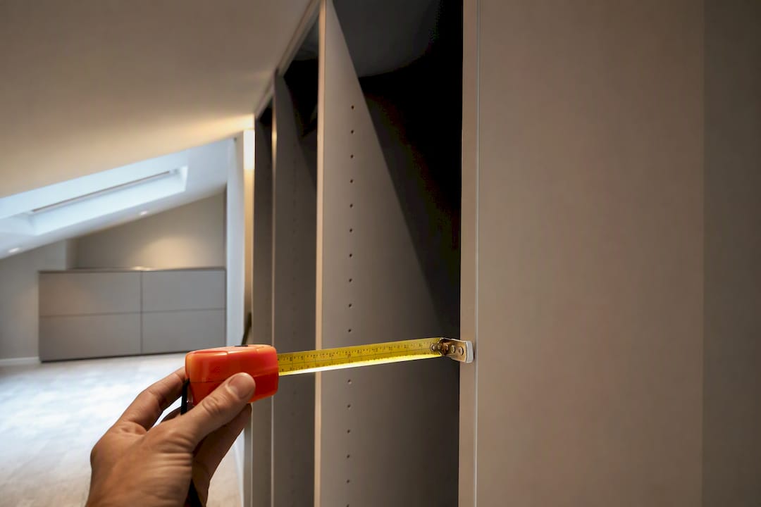Tape measure aligned against wardrobe side panel