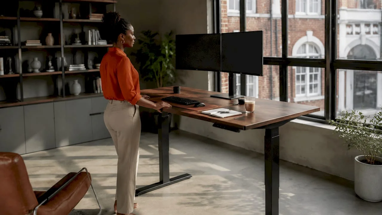 Woman adjusting standing desk in luxury home office