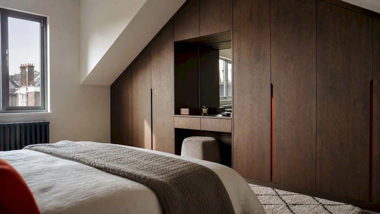 Bespoke fitted wood effect wardrobes in London bedroom